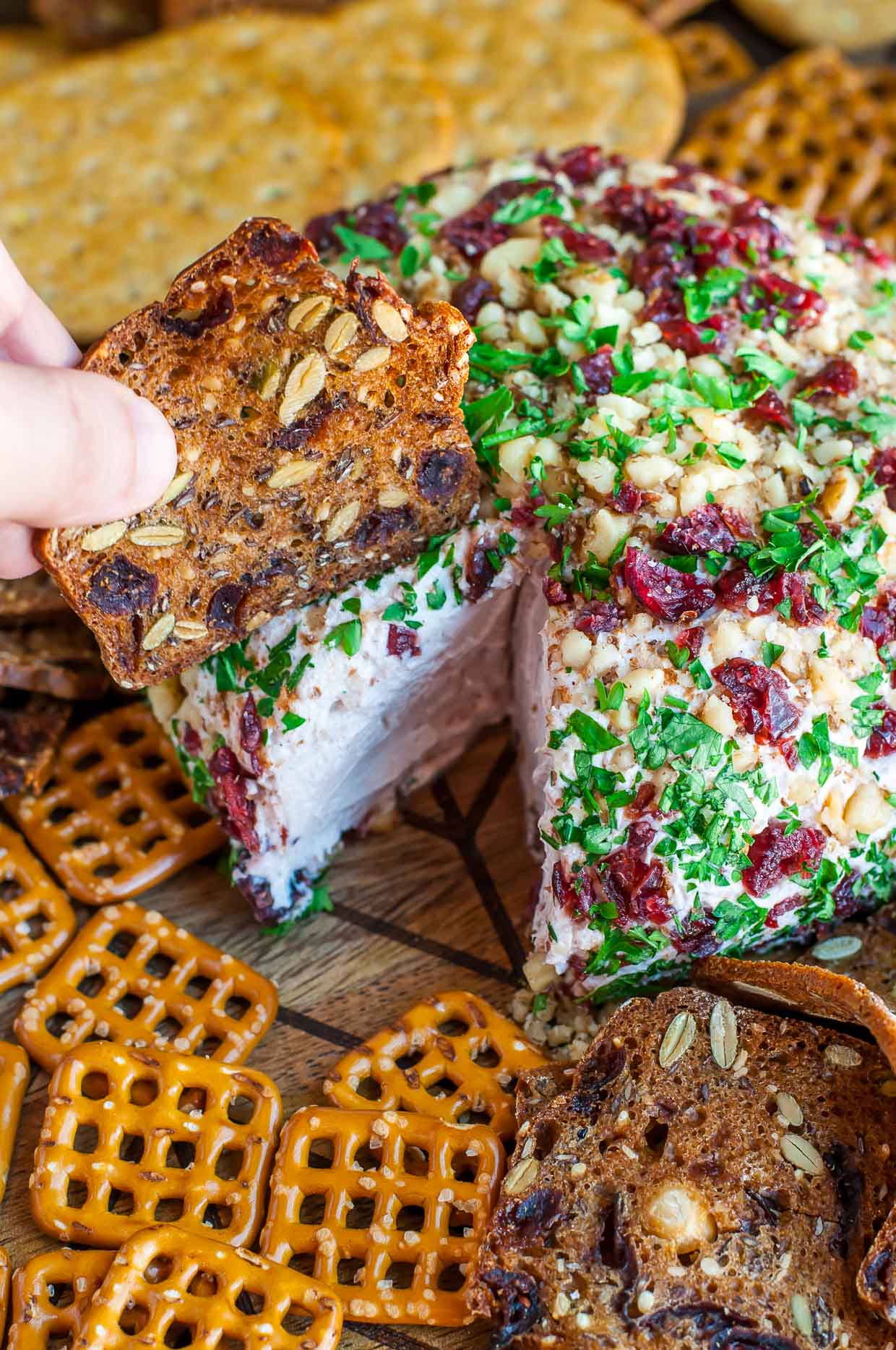 Snag some leftover cranberry sauce and swirl it into this super luxe cranberry walnut holiday cheese ball! Kick it up a notch with sprinkle of cinnamon, a drizzle of honey, and a whole lot of flavor!