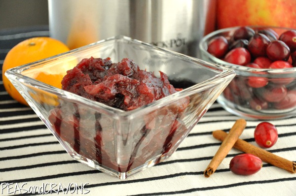 glass serving bowl of crockpot cranberry sauce with cinnamon and orange