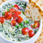 This healthified spinach artichoke dip is going to rock your world! Dive in with a few toasty chips and a pile of crunchy veggies and be prepared to hover over the bowl until it's gone!