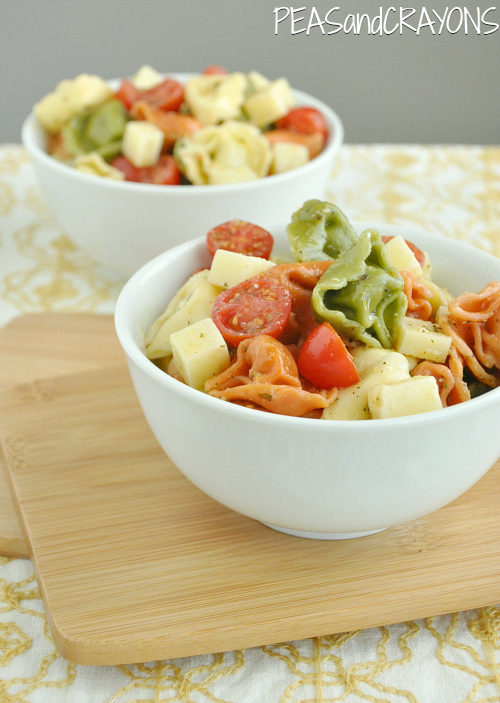 This addictive Tortellini Pasta Salad is tossed with an uber-flavorful homemade dressing and is sure to vanish quickly at your next party or BBQ! :: It's quick, easy, and can be made ahead of time for a tasty grab and go dish!