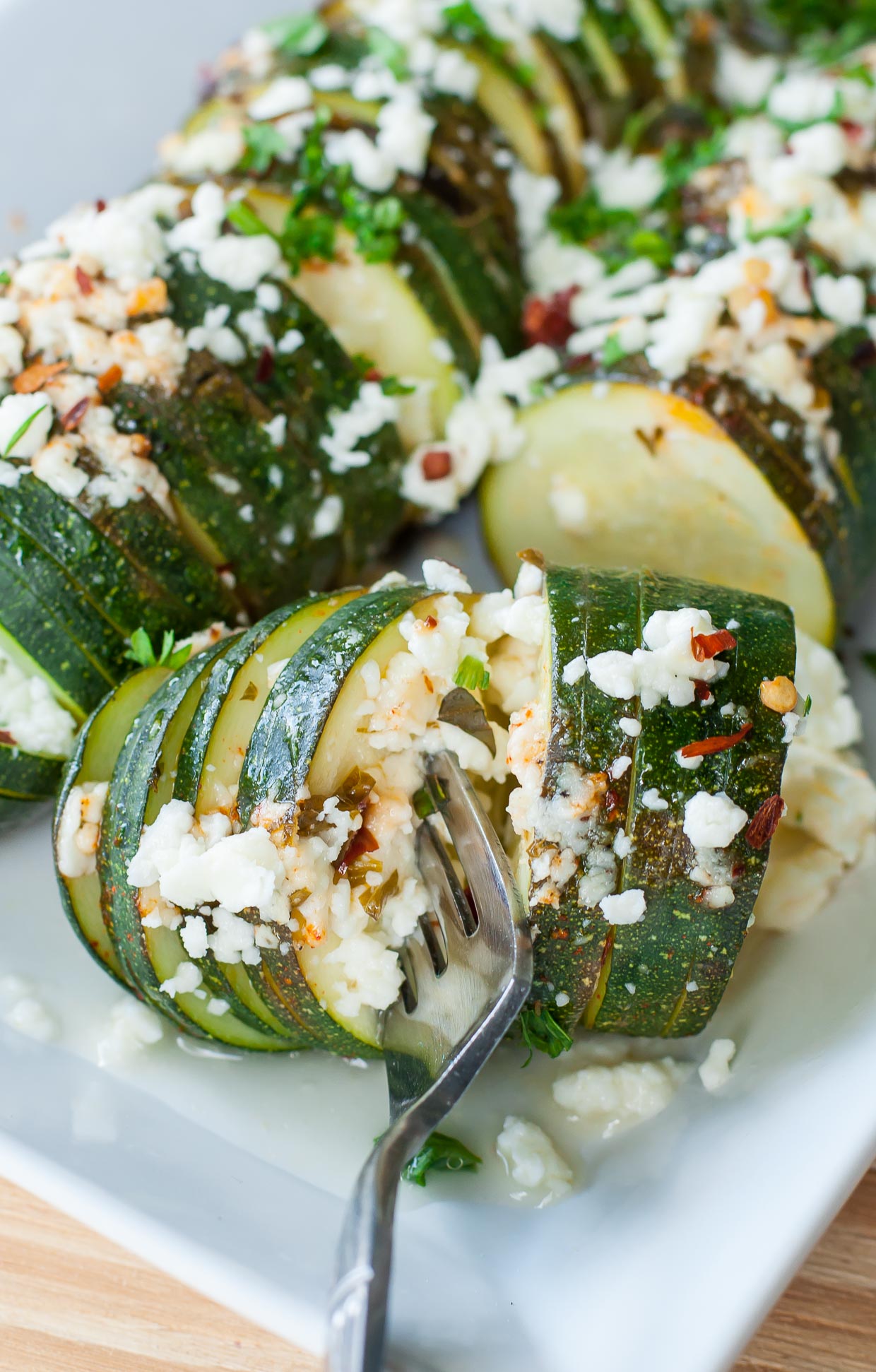 Hasselback zucchini squash drizzled in evoo and topped with lemon, basil and creamy feta cheese. This speedy foil-baked side is sure to impress and SO easy to make!