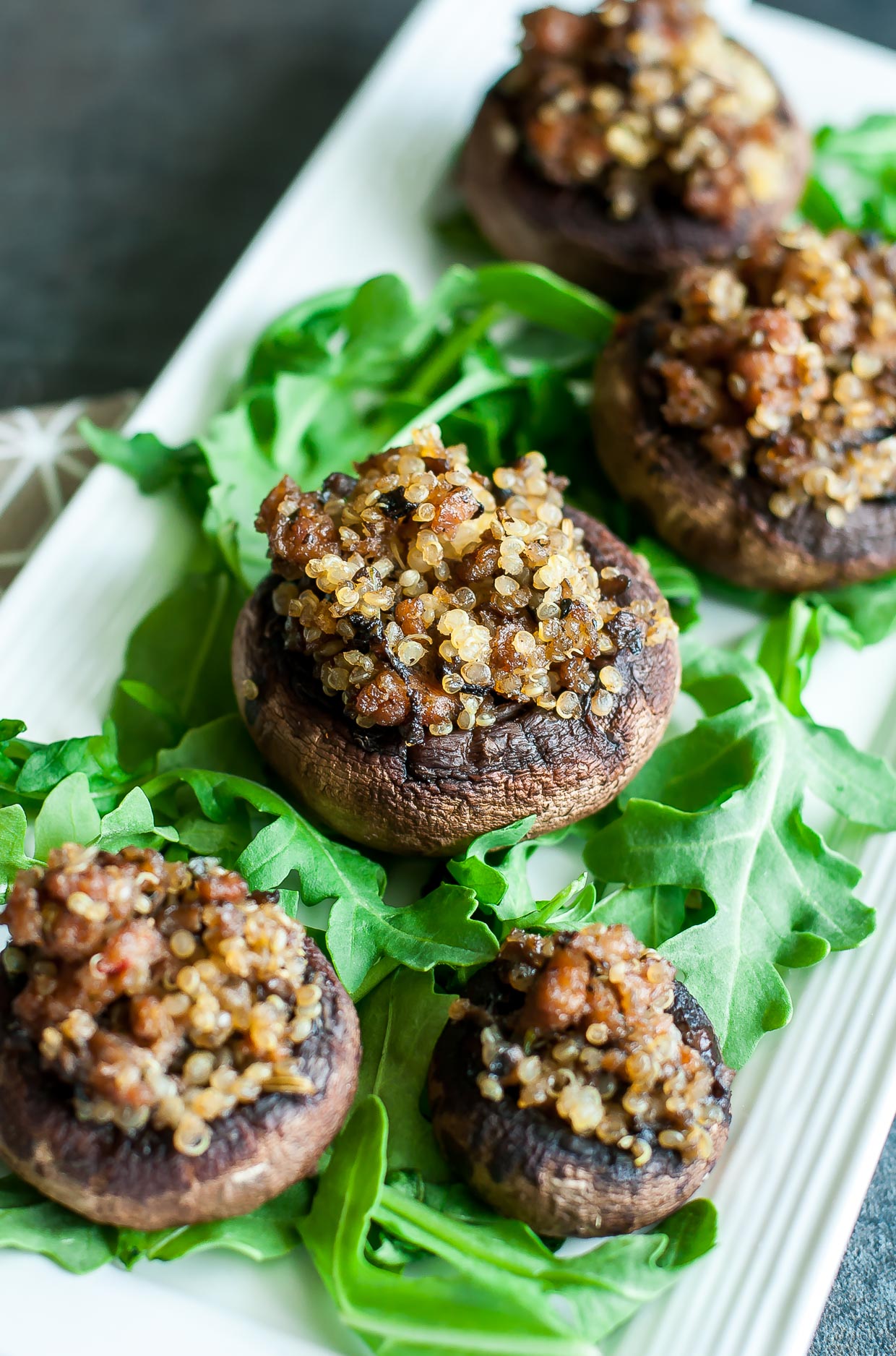 Betcha can't eat just one of these Sausage and Quinoa Stuffed Mushrooms! This delicious party appetizer is wildly addictive and gloriously gluten-free too.