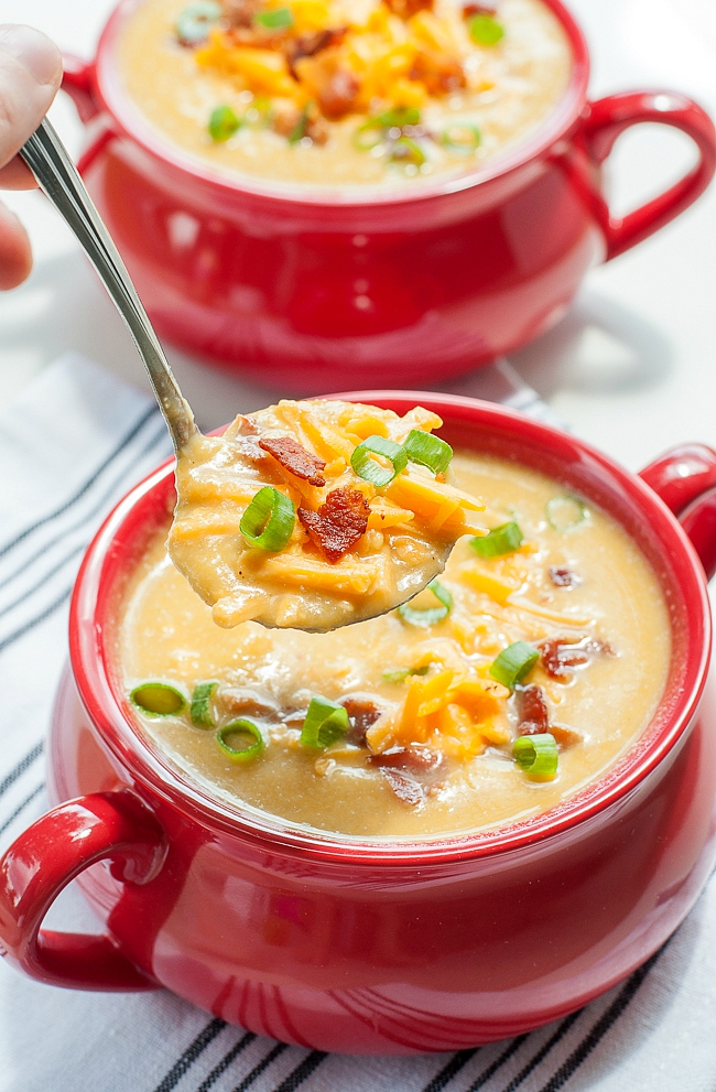 Creamy cauliflower soup like you've never had it before! This Slow Cooker Sweet Potato and Cauliflower Soup recipe is positively delicious and so easy to make