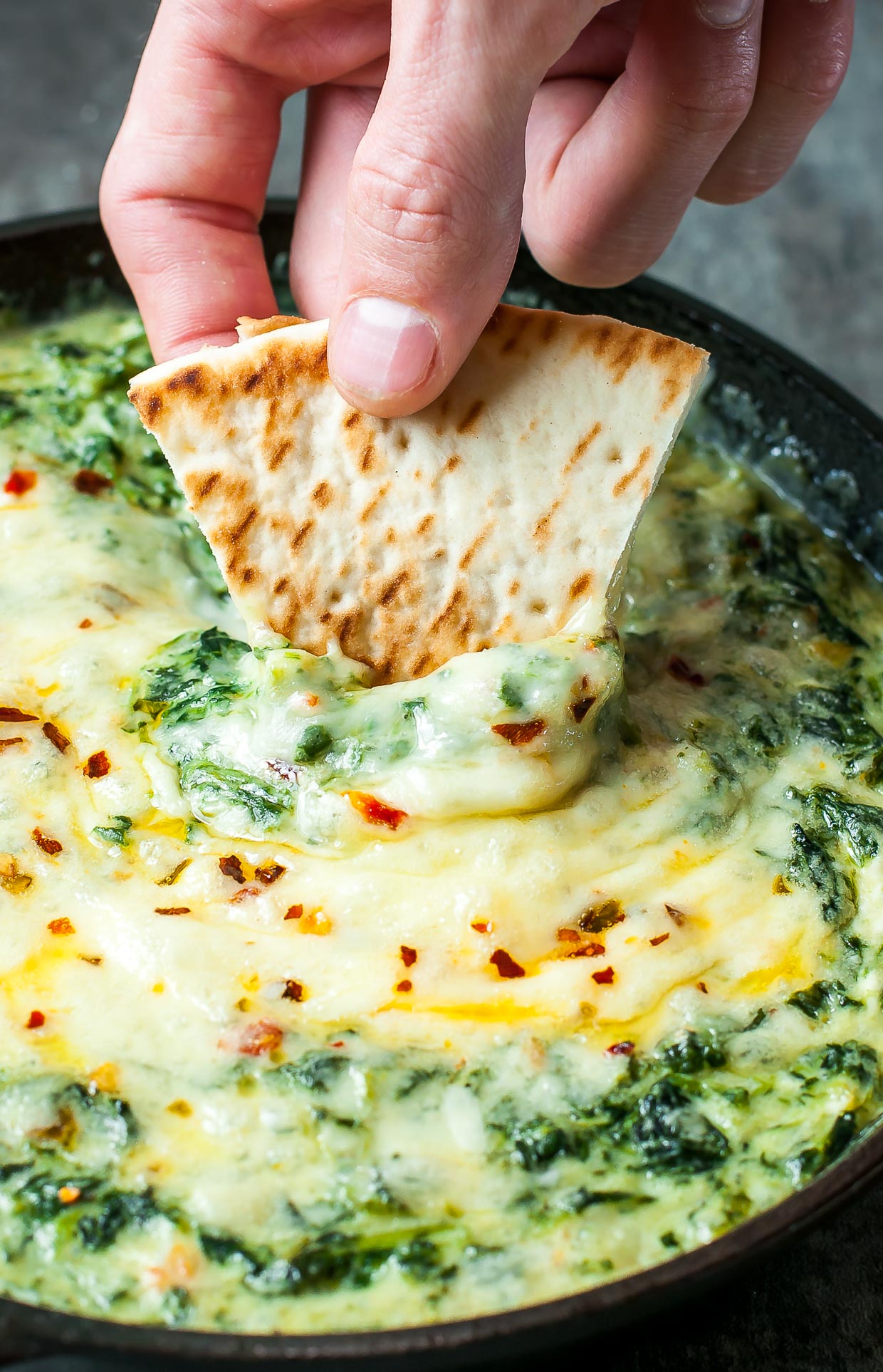 Serve this Cheesy Baked Shrimp and Spinach Dip at your next party and it's sure to be the first dish devoured! My friends and family BEG for this easy cheesy appetizer!