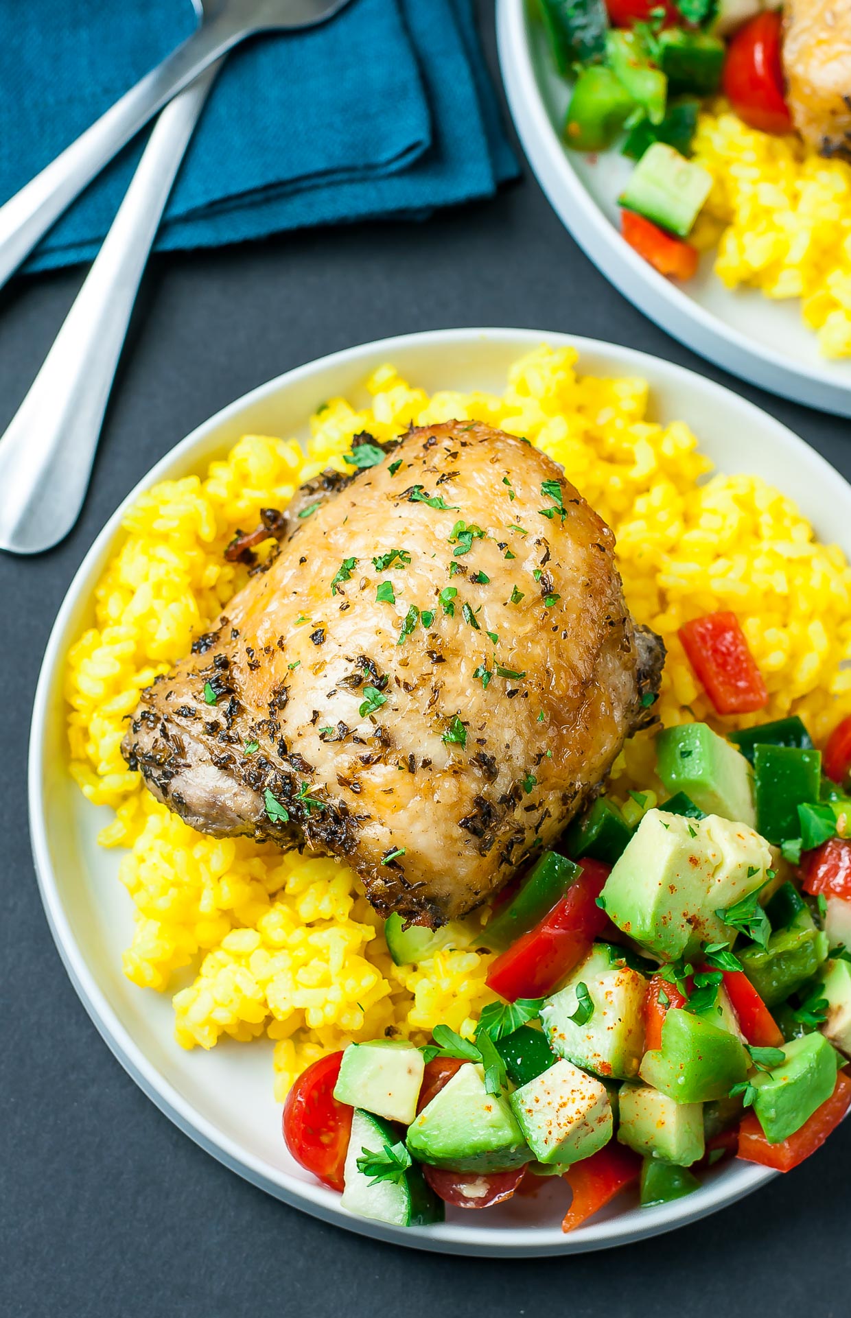 Baked to crispy perfection, these tender chicken thighs are seasoned with a homemade Mediterranean marinade and served with vibrant garlic turmeric rice. This simple weeknight dinner is easy to throw together and full of flavor!