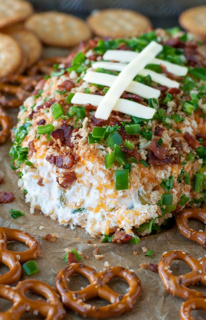 Jalapeño Popper Football Cheese Ball with bacon, panko, jalapenos, and mozzarella cheese on top