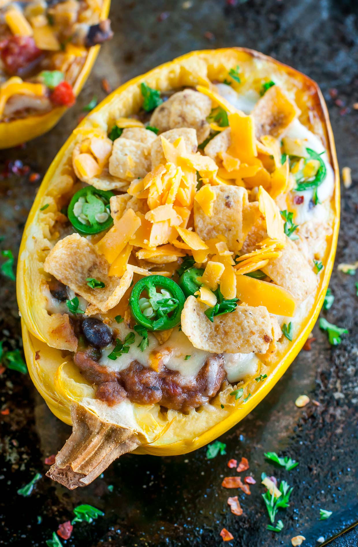 These easy cheesy Chili Stuffed Spaghetti Squash are 100% vegetarian and totally crave-worthy! Each GF squash boat can easily be made vegan or paleo too!