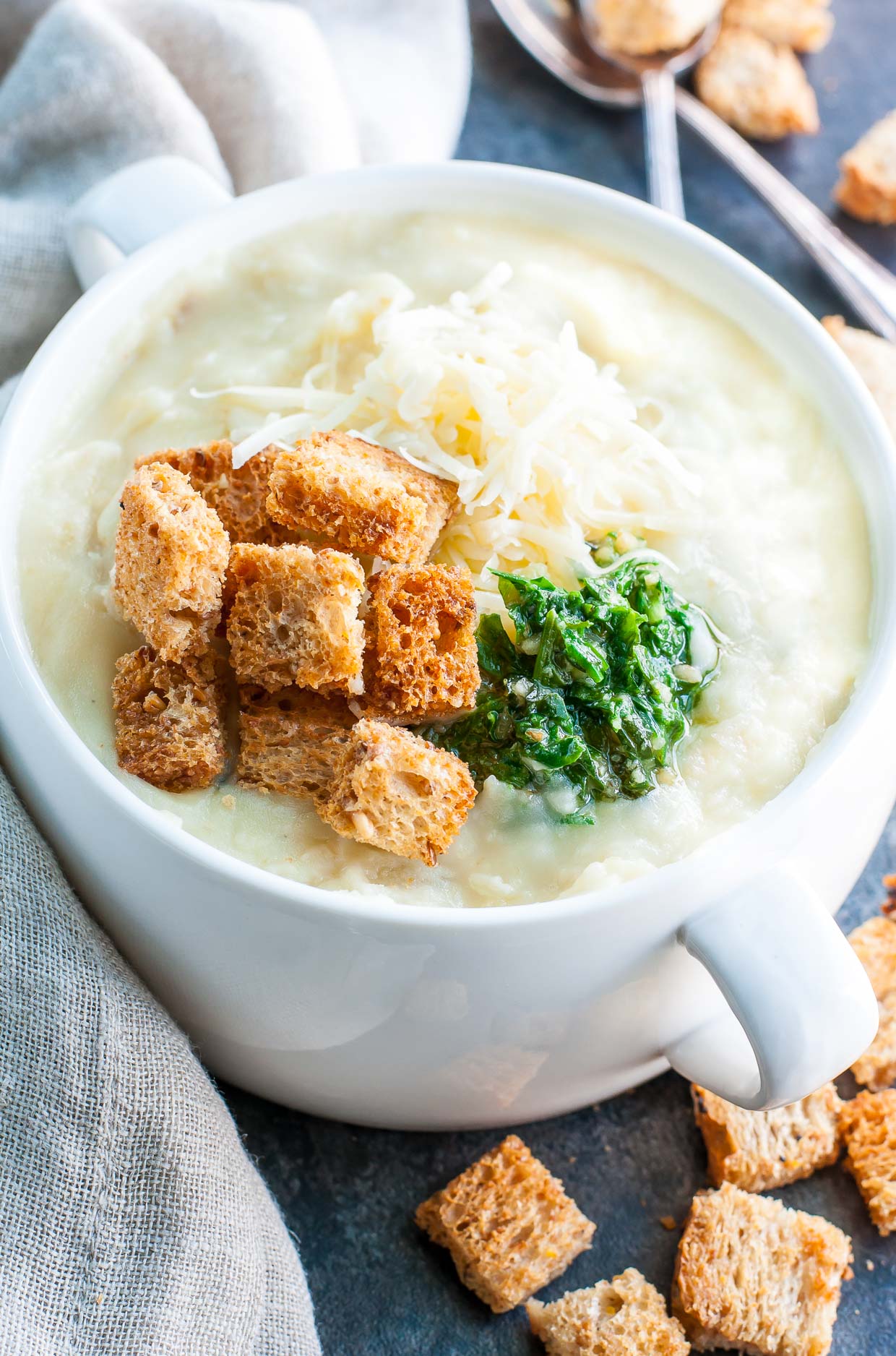 Creamy potato soup is the ultimate comfort food! This Cheesy Pesto Potato Soup is a lighter twist on the classic with all the bowl-licking flavor of the original! Instant Pot + Slow Cooker