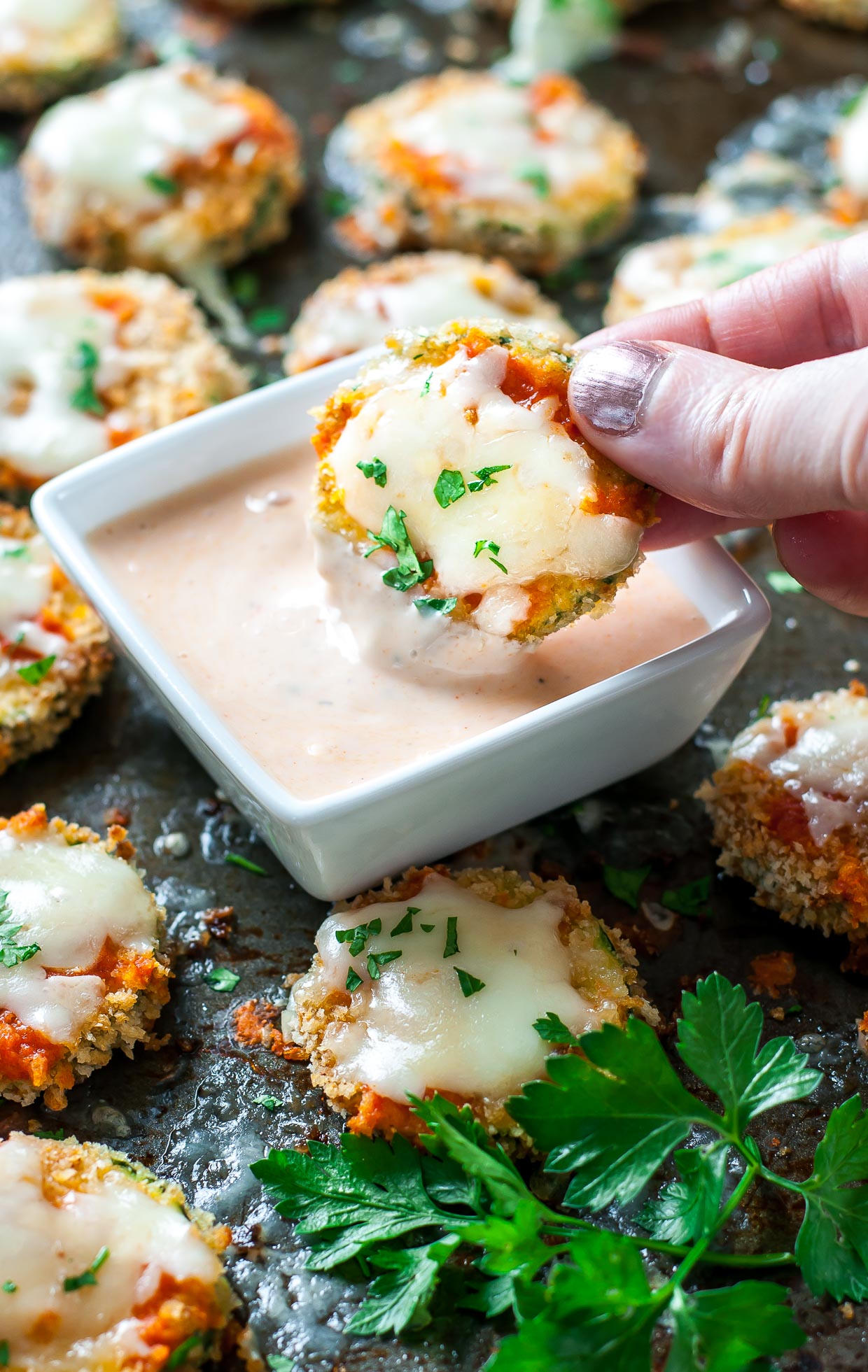 Cheesy Baked Buffalo Zucchini Chips let veggies in on the fun of game day snacking! Add buffalo sauce to your favorite ranch for a delicious dip.