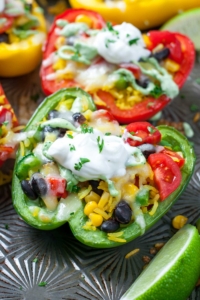 These Cheesy Southwest Stuffed Peppers with Cilantro Avocado Sauce prove that vegetarian eats can be tasty and filling!