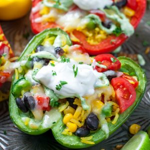 These Cheesy Southwest Stuffed Peppers with Cilantro Avocado Sauce prove that vegetarian eats can be tasty and filling!