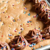 Homemade Sheet Pan Cookie Cake Recipe - This classic chocolate chip cookie cake is a total game changer in sheet pan form! Serves a crowd.