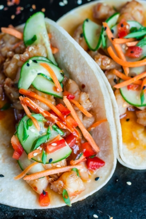 Szechuan Shrimp Tacos with Cool Cucumber Slaw are ready to shake up your taco game! A fun fusion of two of my all-time favorites, these tasty tacos are ready to rock your plate in under 20 minutes.