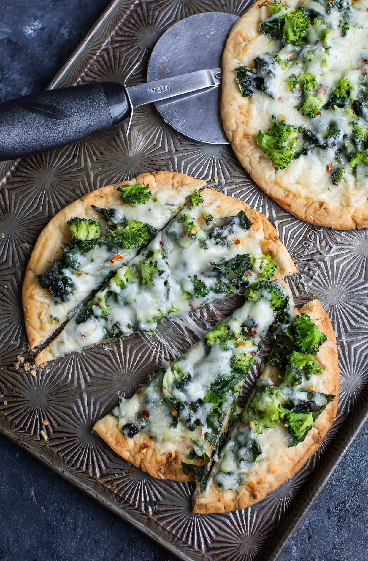 This cheesy broccoli kale pesto pizza uses store bought flatbread for a fast and flavorful personal pizza, perfect for busy weekdays!