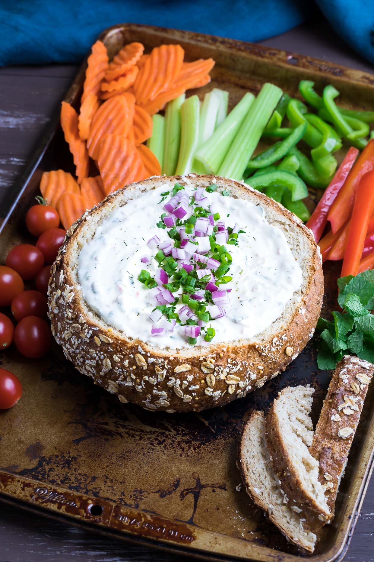 This party-perfect Chilled Veggie Dip is served in a bread bowl with crunchy veggies for a tasty snack that will have your guests coming back for more!