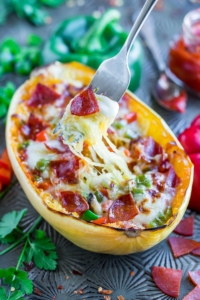 Whip up these Veggie Lover's Spaghetti Squash Pizza Boats for a low-carb + gluten-free pizza night of epic proportions!
