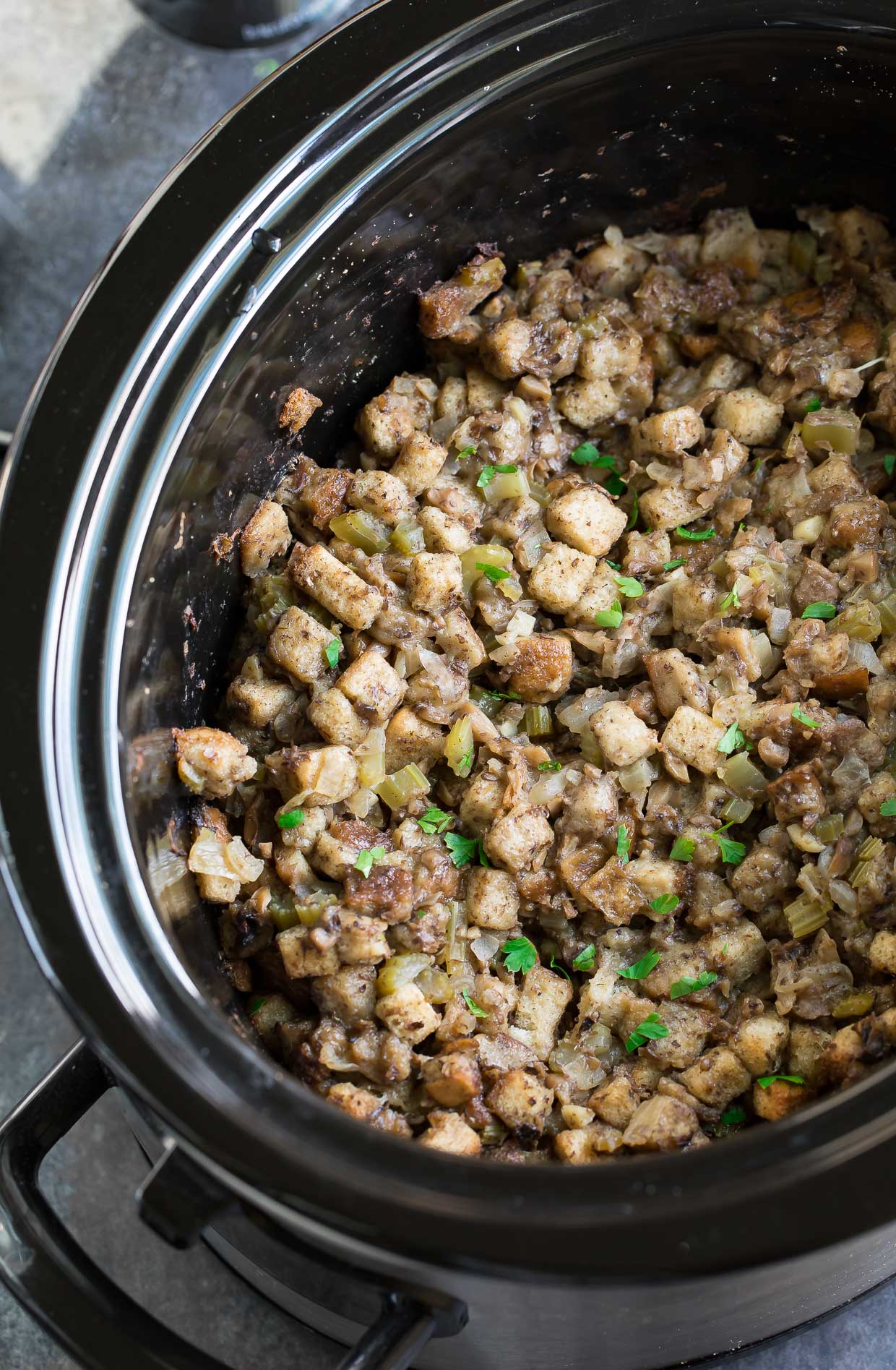 Save precious oven space with this classic Slow Cooker Stuffing recipe! Since converting my mom's Thanksgiving stuffing to the crock-pot I've been OBSESSED with the results. It comes out perfectly tender on the inside and crisp on the outside!