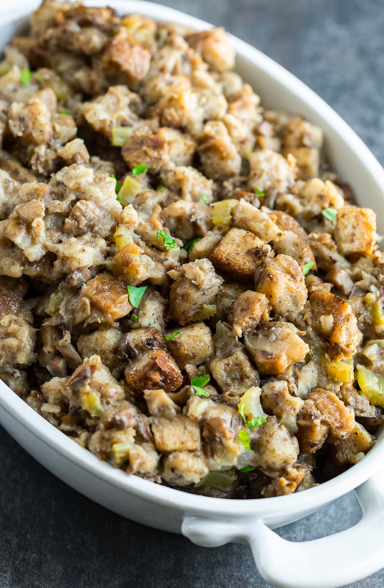 Save precious oven space with this classic Slow Cooker Stuffing recipe! Since converting my mom's Thanksgiving stuffing to the crock-pot I've been OBSESSED with the results. It comes out perfectly tender on the inside and crisp on the outside!