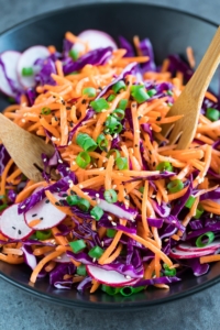 This vegan + paleo Whole30 Carrot Slaw is quick, easy, and full of flavor! Mayo-free with no sweeteners added, it's a light and healthy option and great with everything!