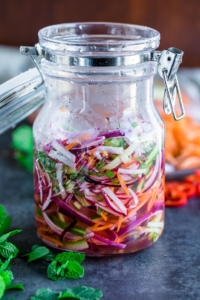 Quick Fridge Pickled Vegetables make the ultimate topping for tacos, burgers, and more! Featuring a blend of carrots, cucumber, radish, and onion, this healthy recipe is fast and flavorful!