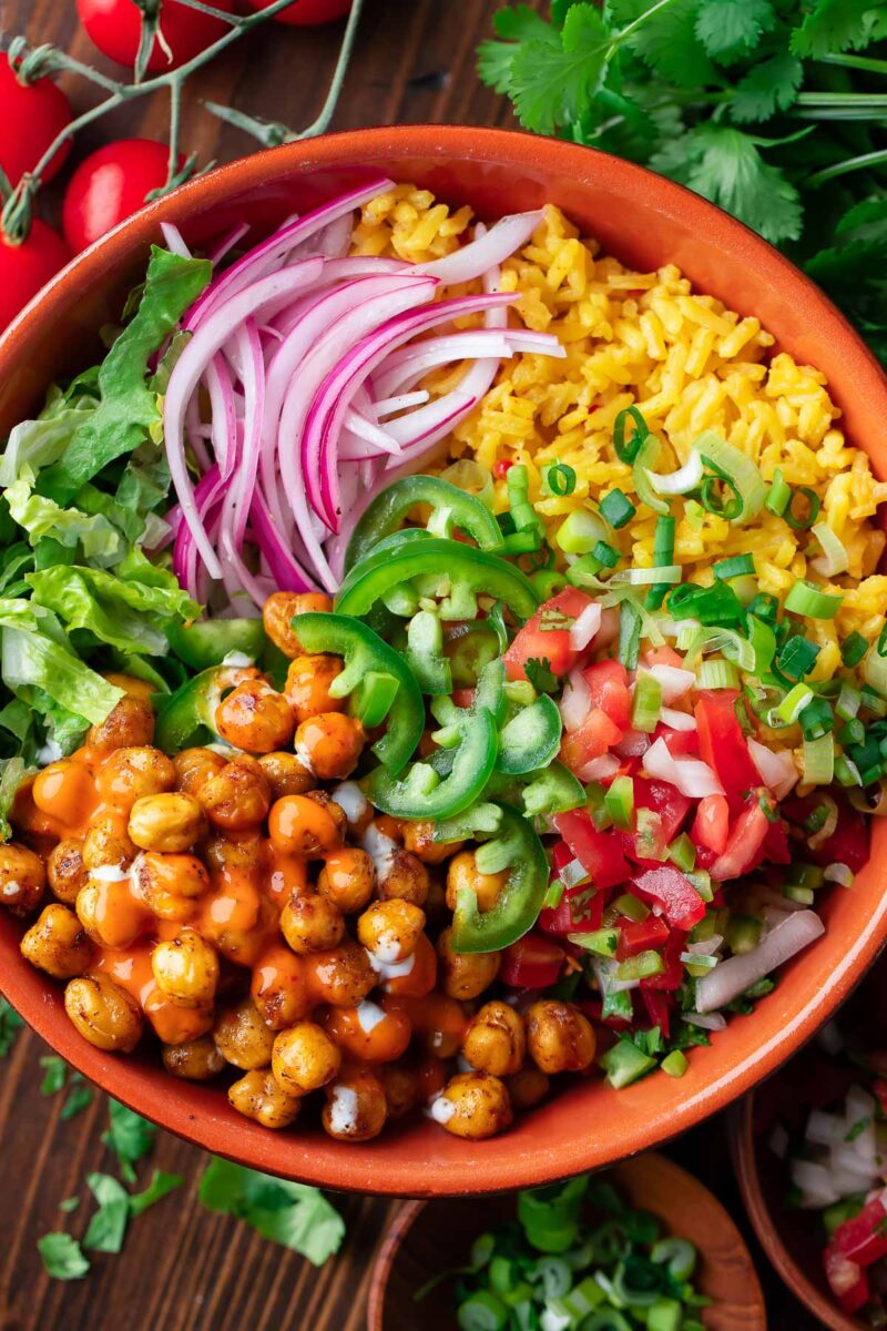 Yellow Rice Burrito Bowl with Crispy Chickpeas, Salsa, Peppers, Onion, and Lettuce