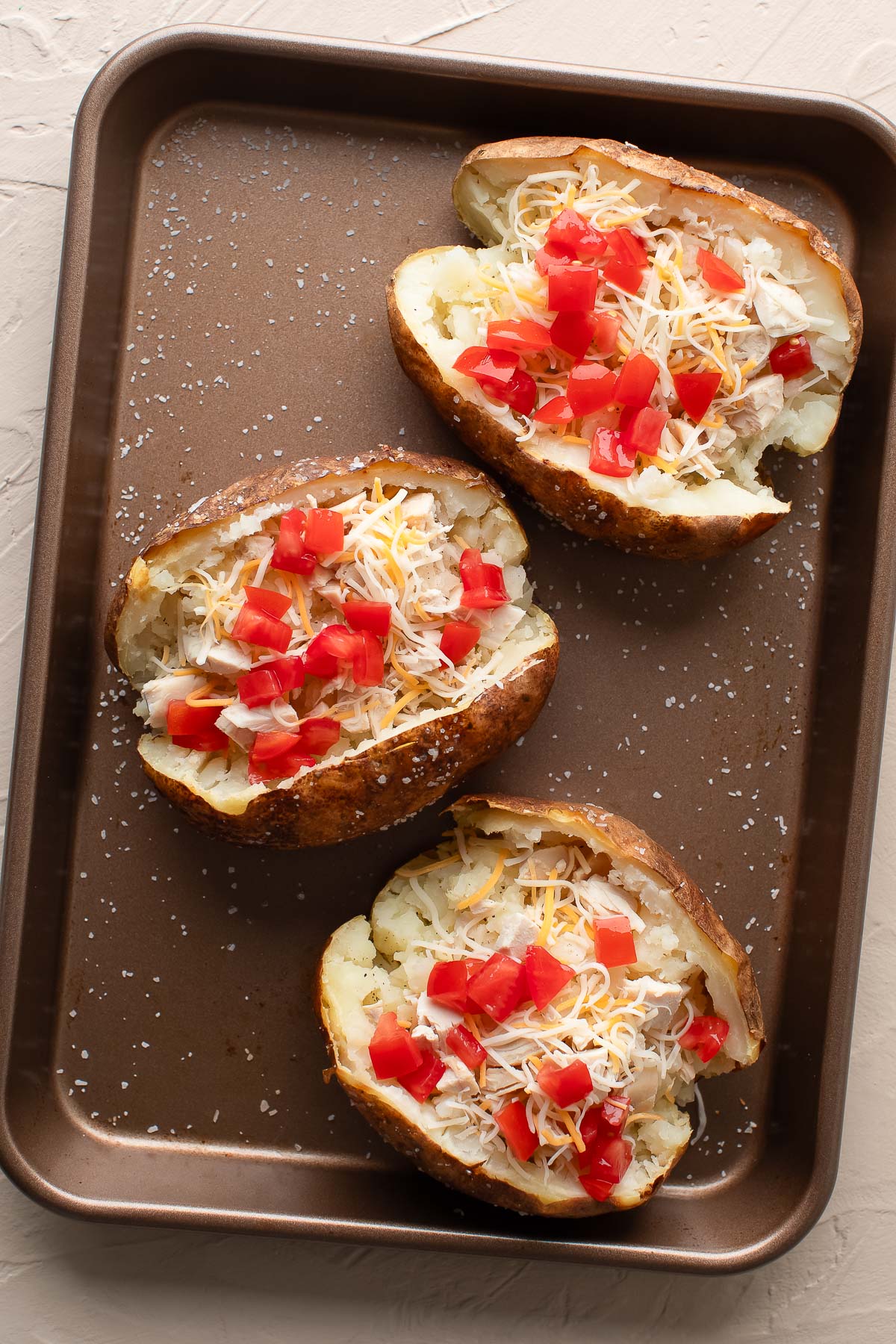 Baked Potatoes with Chicken, Cheese, and Tomatoes