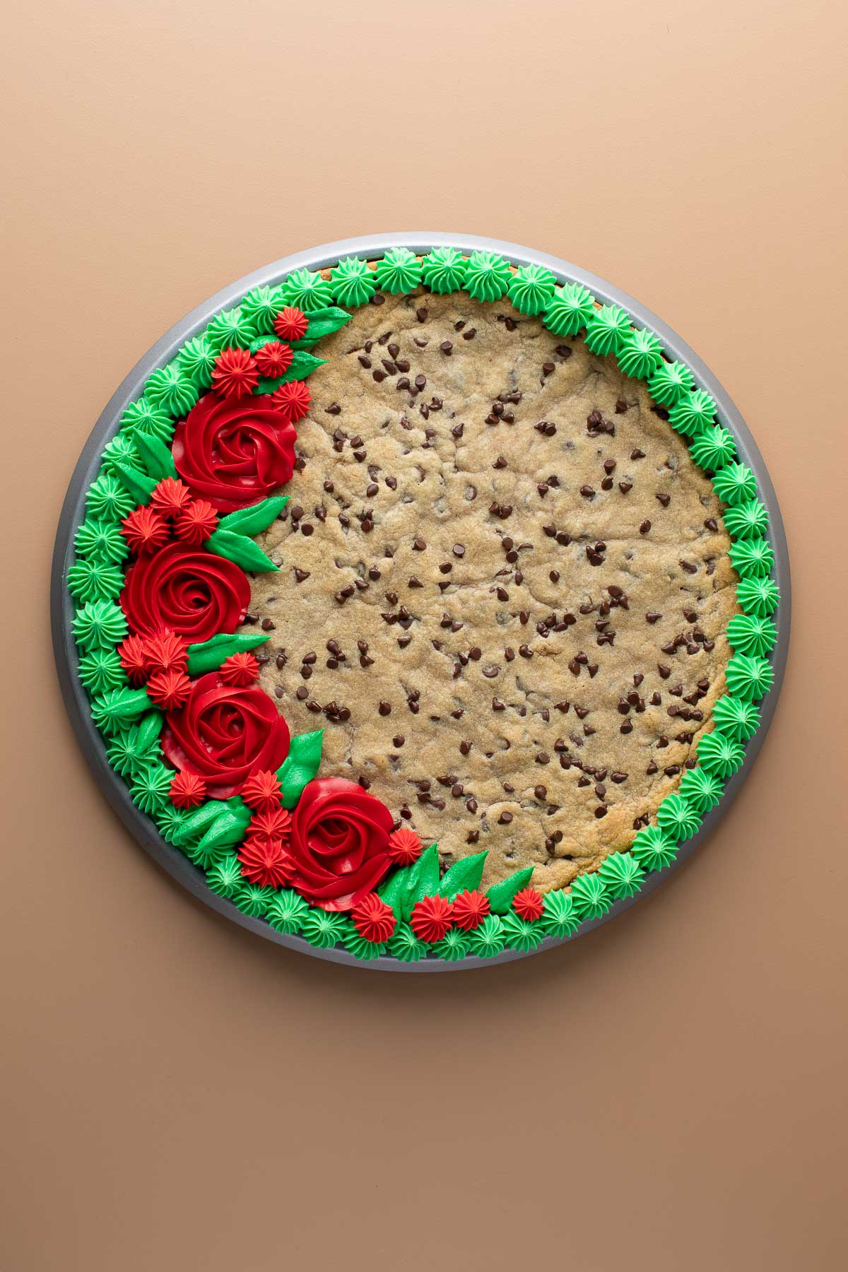 cookie cake with buttercream frosting roses and flowers