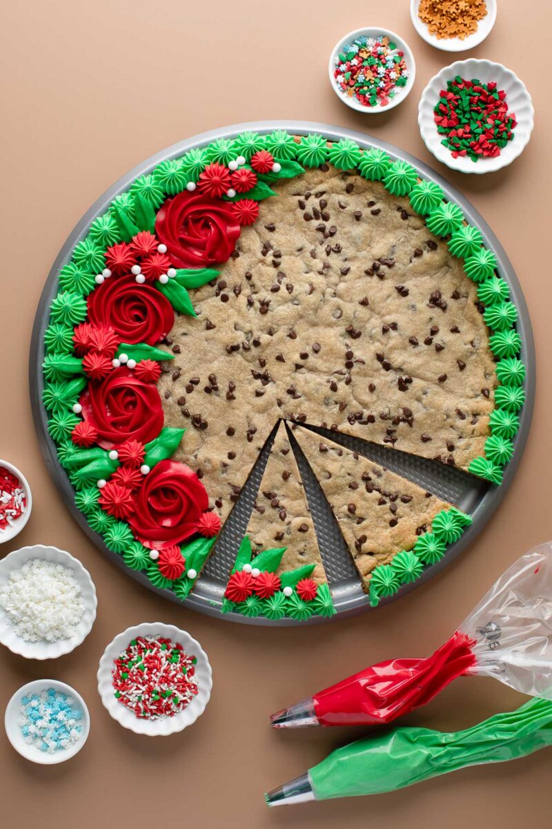 christmas cookie cake with wreath decorations in frosting and assorted sprinkles