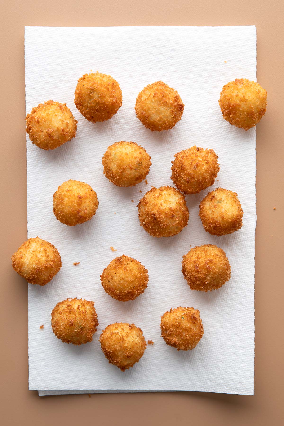 transfer mashed potato balls from hot oil to paper towels to drain