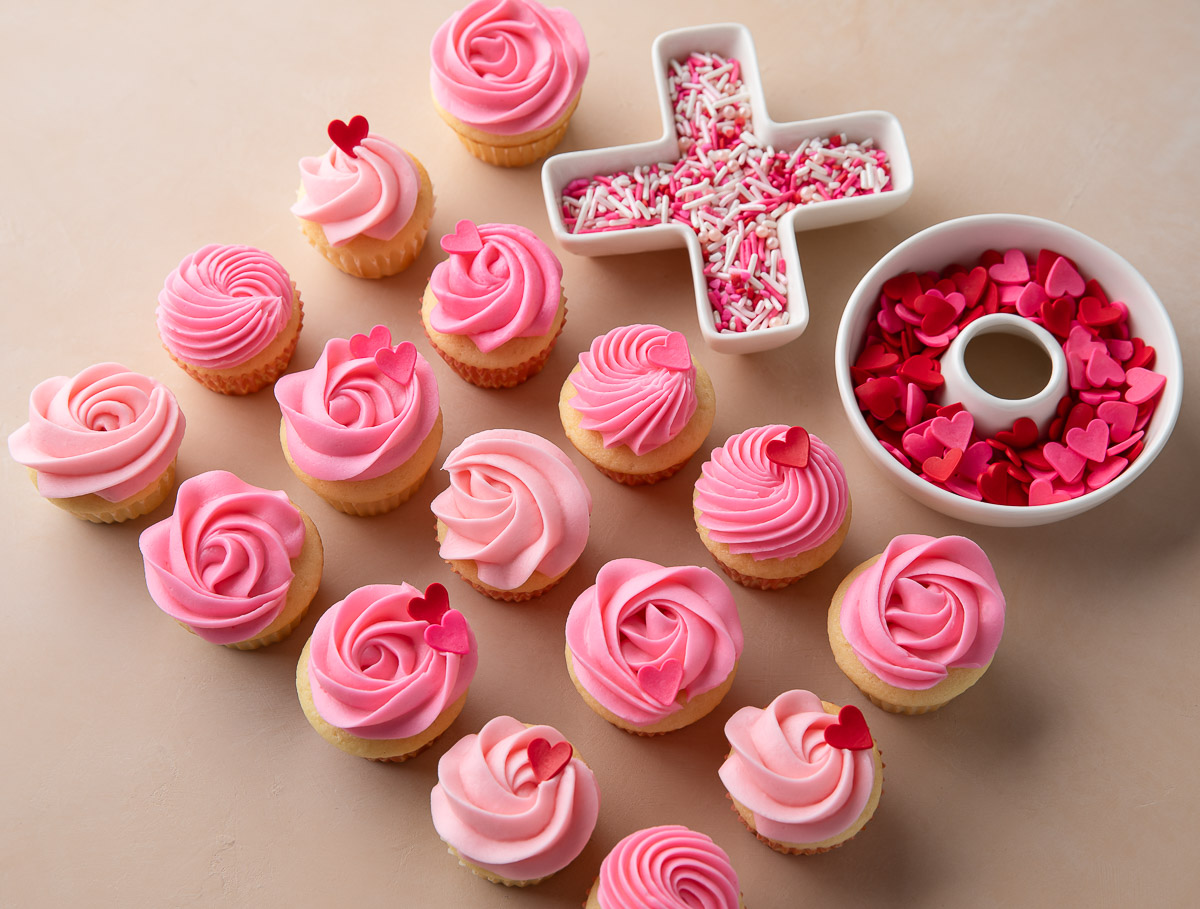 pink mini cupcakes with frosting and sprinkles