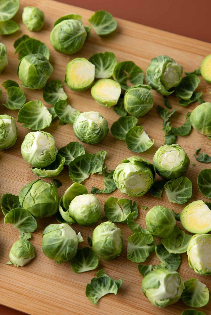 trimmed brussels sprouts on wooden cutting board