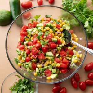 avocado salsa with tomatoes, corn, red onions, jalapeno peppers, cilantro, and lime.