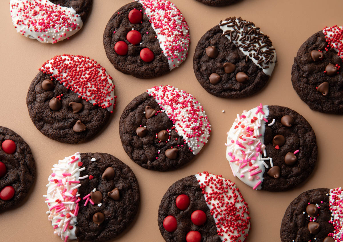 White Chocolate Dipped Cookies topped with assorted red and pink sprinkles