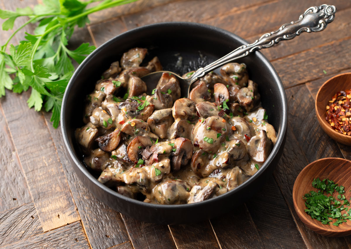 bowl of creamy mushrooms with garlic and parmesan