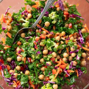 Kale Crunch Salad with chickpeas, carrots, purple cabbage, broccoli, green onions, and red bell pepper