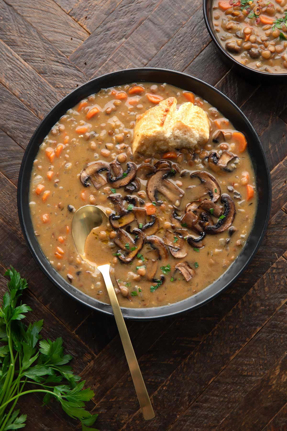 bowl of Mushroom Lentil Soup with bread for dunking