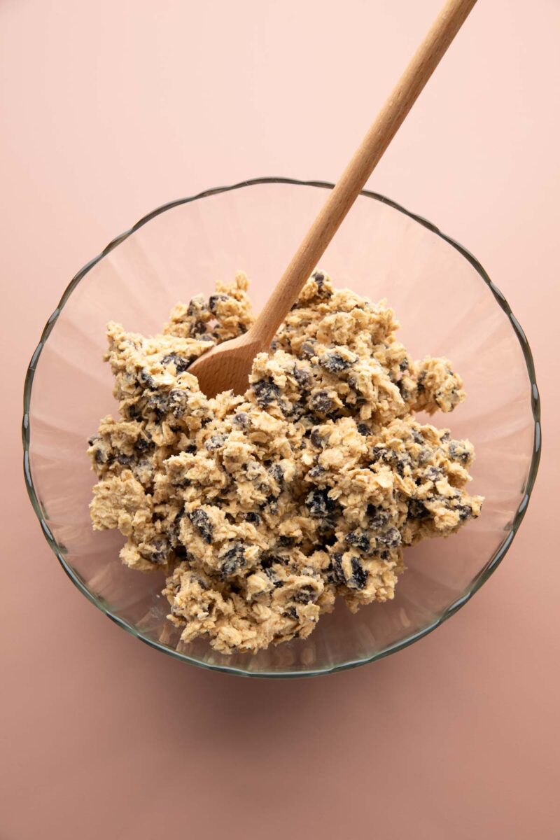 mixing up oatmeal cookie dough with chocolate chips and dried cherries