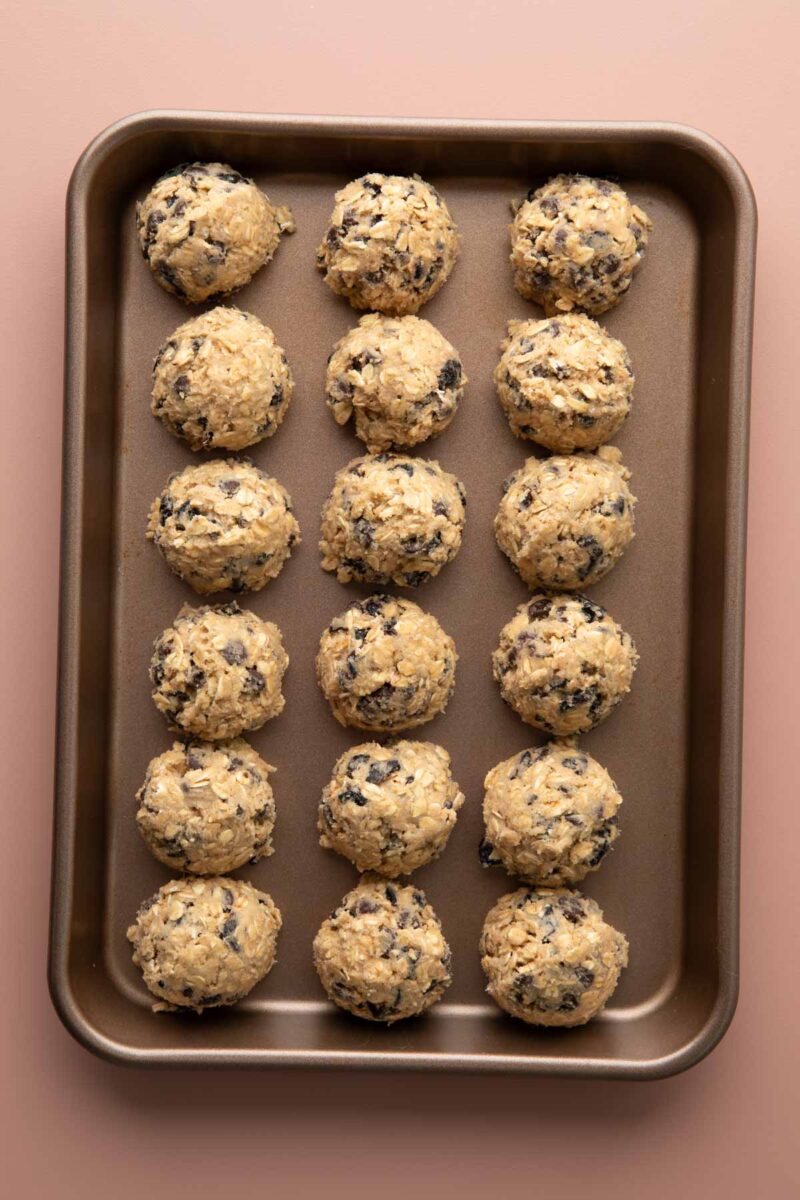 cookie dough scoops in a sheet pan before baking