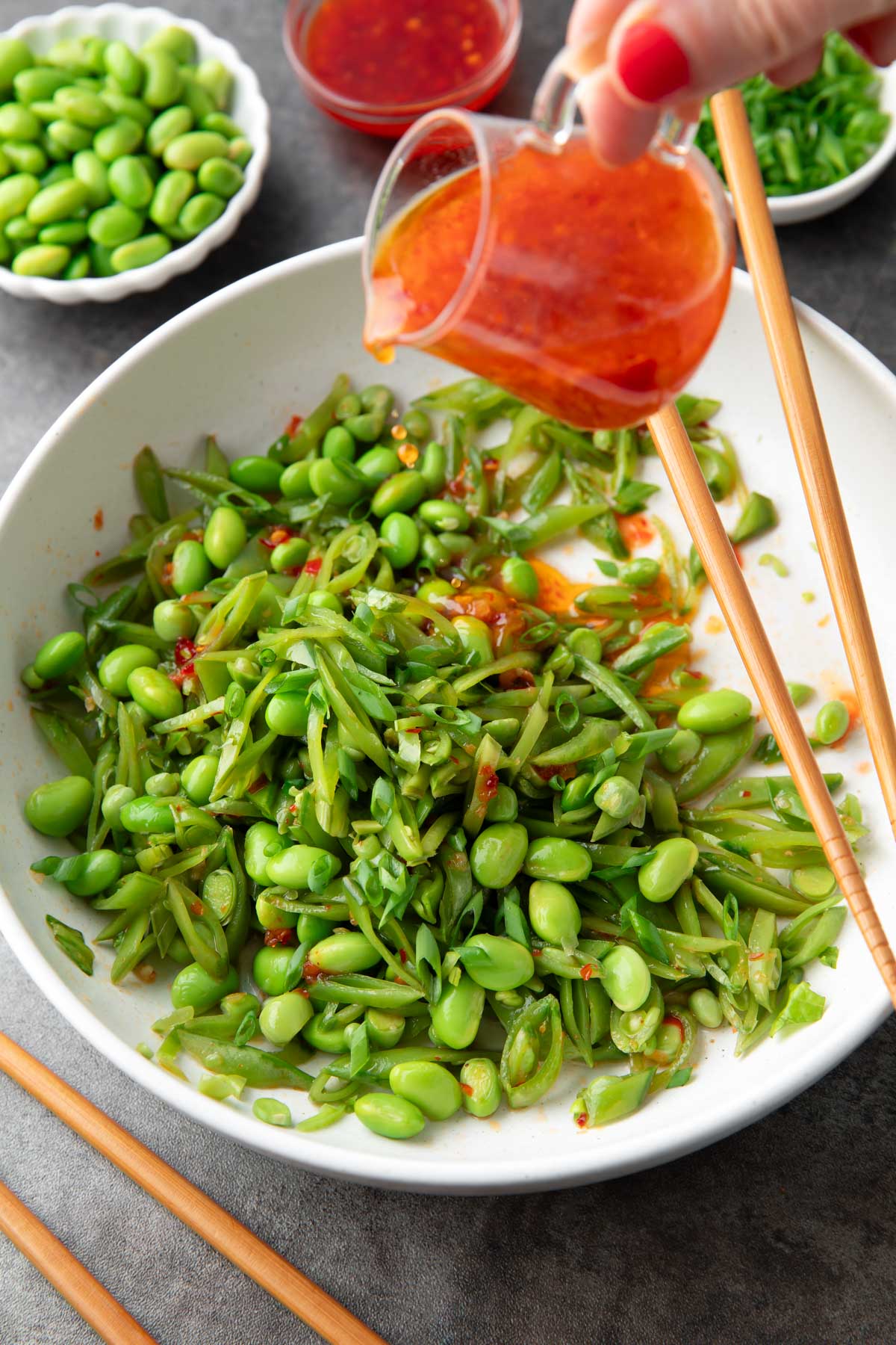 Snap Pea Salad with Sweet Chili Dressing poured over the top