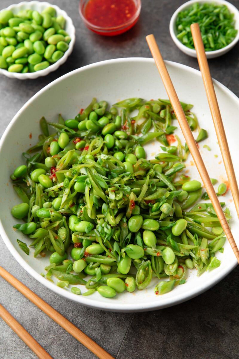 snap pea salad tossed with edamame, scallions, and sweet chili dressing
