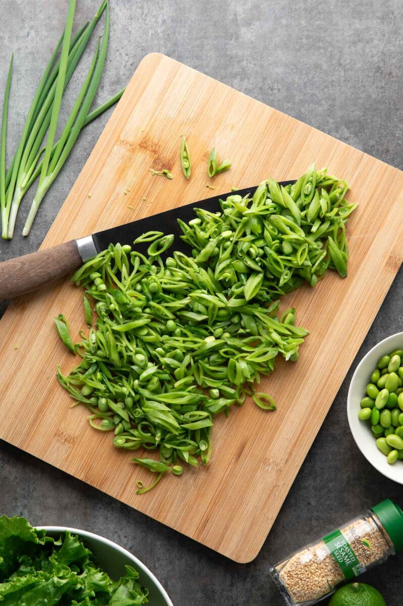 chopped sugar snap peas on a cutting board